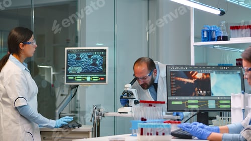 Preview: Man research scientist looking at samples under microscope
