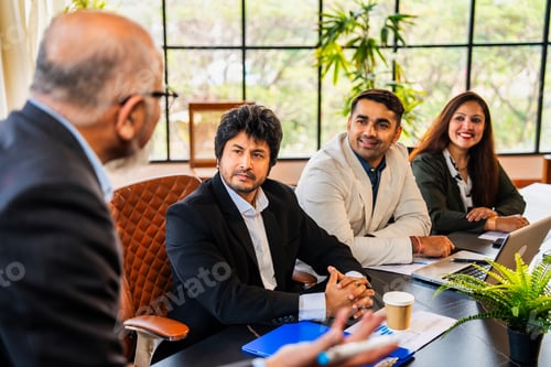 Preview: Indian Senior business leader addressing young professionals with strategy ideas in conference room