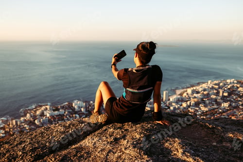 Preview: Back view of sportswoman relaxing during trail run