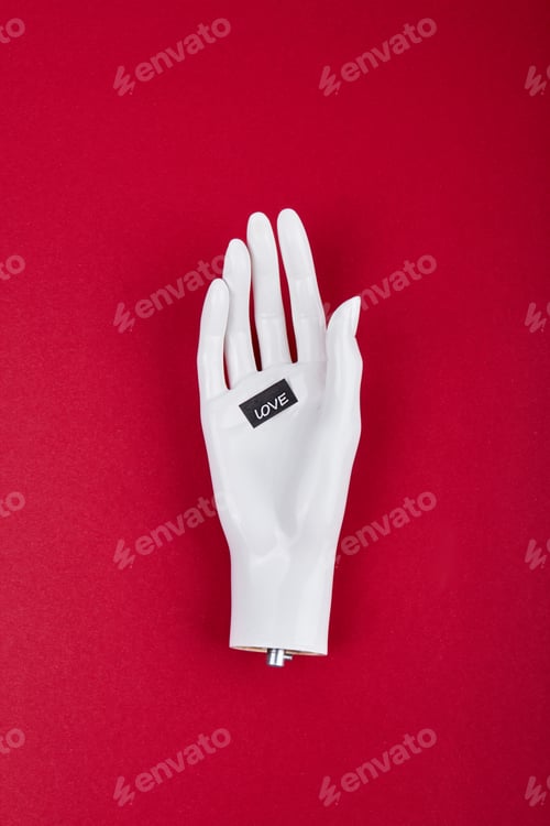 Preview: White mannequin hand with love word.