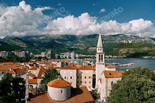 Preview: Church of the Holy Trinity near St. John Cathedral among old houses with red roofs. Budva