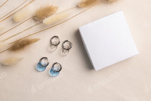 Preview: Elegant jewelry set of silver earrings with gem and gift box mock up copy space. Jewelry set