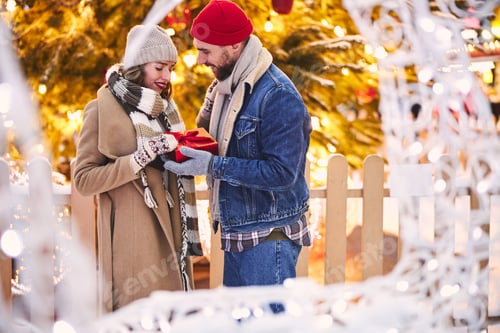 Preview: Jolly caring couple celebrating New Year in city centre