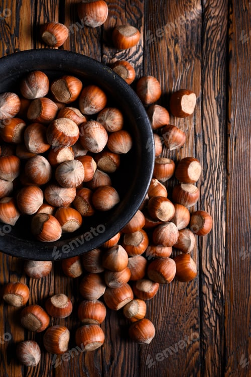 Preview: Hazelnut nuts pour out of wooden rustic table