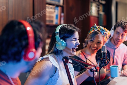 Preview: young people having fun in on line streaming podcast - selective focus on headphones