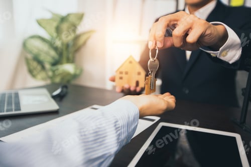 Preview: real estate and selling house concept, bank agent give key of home to customer