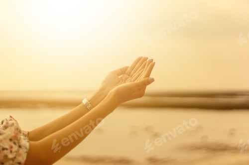 Preview: Young woman praying Hands at sunset