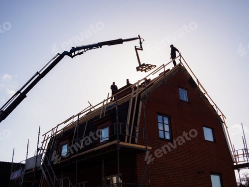Preview: Silhouette of men and crane at construction site