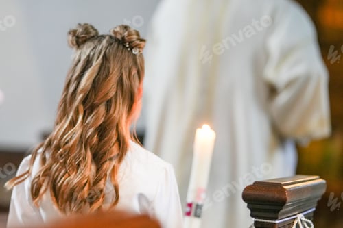 Preview: Closeup shot of a young girl holding a white candle