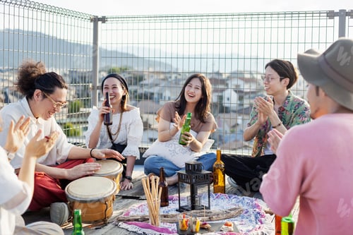 Preview: Group of young Japanese men and women standing on a rooftop in an urban setting.