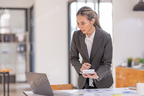 Preview: Portrait of a business Asian woman working at office reading and checking searching document tax a