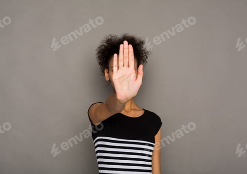 Preview: Young woman covering her face with palm