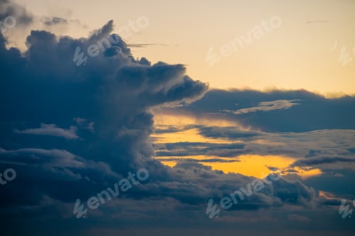 Preview: Dramatic Sunset Sky with Golden Light and Dark Storm Clouds