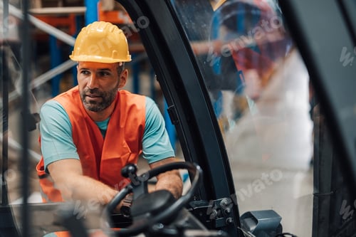 Preview: Warehouse worker driving forklift in warehouse