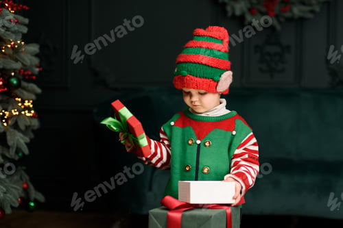Preview: Merry Christmas and Happy Holidays. Surprised cute child girl opening present.