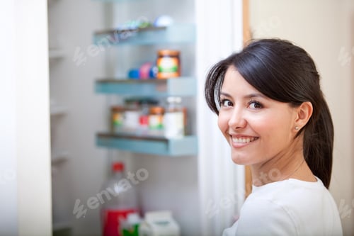 Preview: Woman At Home Looking Inside The Fridge And Smiling