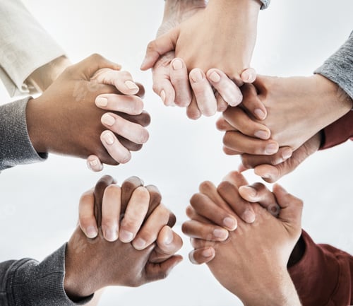 Preview: Below view of people holding hands in circle shape. A group of people putting their hands together