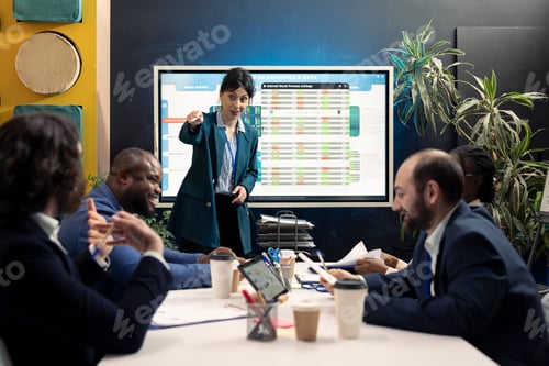 Preview: Teammates gathering in a conference room for meetings to go over their input