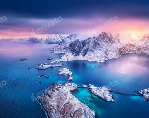 Preview: Aerial view of snowy mountains in low clouds, islands and rocks