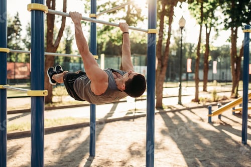 Preview: Man doing exercise on press using horizontal bar