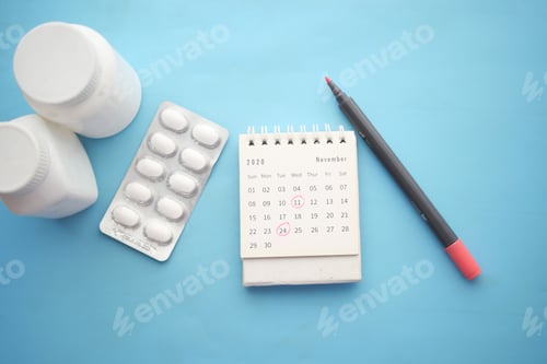 Preview: medical pill container and calendar on color background
