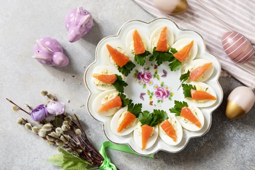 Preview: Stuffed eggs with cheese and salted salmon in the form of a carrot. View from above.