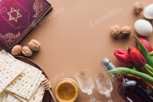 Preview: top view of traditional book with text in hebrew, honey and matza on brown table