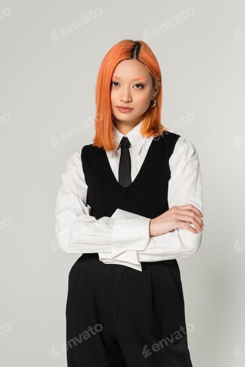 Preview: portrait of attractive and young asian woman in white shirt, black tie, vest and pants standing with
