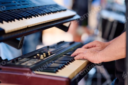 Preview: Rock band performs live at outdoor concert with keyboards on stage