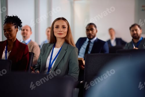 Preview: Female entrepreneur attending a business seminar at conference hall.
