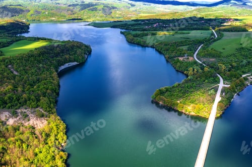 Preview: Spectacular aerial view from a drone to a lake and a road between hills. Yovkovtsi, Bulgaria