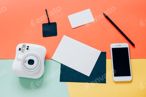 Preview: Creative flat lay style of workspace desk with instant camera