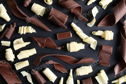 Preview: Yummy chocolate curls on black background, top view