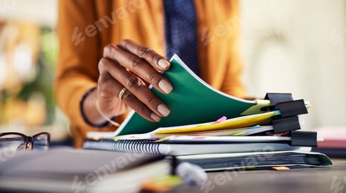 Preview: African american woman checking documents while working at creative office