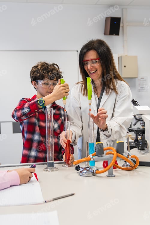 Preview: Chemistry teacher helping student using pipette in laboratory