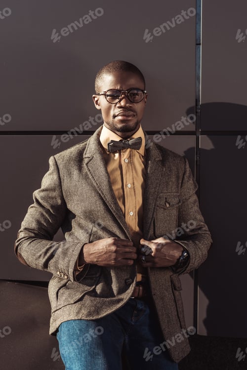 Preview: Handsome african american man in formal wear and eyeglasses, buttoning up jacket