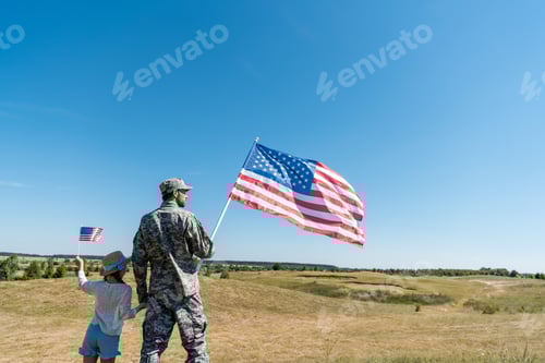 Preview: Man and Child with American Flags Outdoors