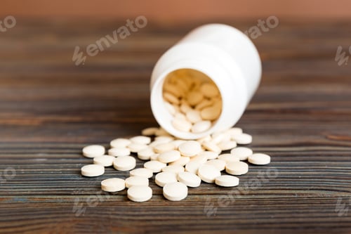Preview: Medicine bottle and white pills spilled on a light background. Medicines and prescription pills