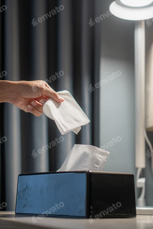 Preview: Woman hands taking paper tissue out of box