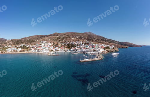 Preview: Andros island Batsi Cyclades Greece. Aerial drone view of port boat, building, sandy beach sea sky.