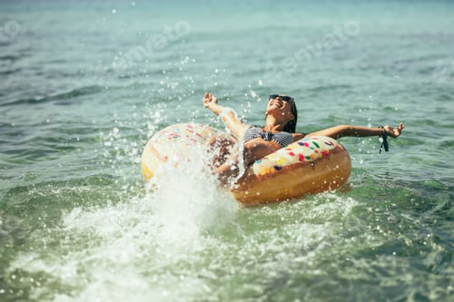 Preview: Woman Riding on Inflatable Donut