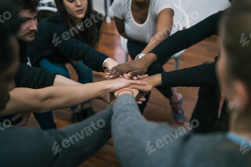 Preview: Team of work showing unity with their hand together.