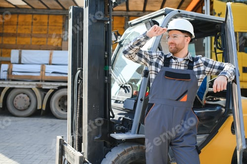 Preview: Portrait of heavy industry forklift driver giving thumbs up and smiling