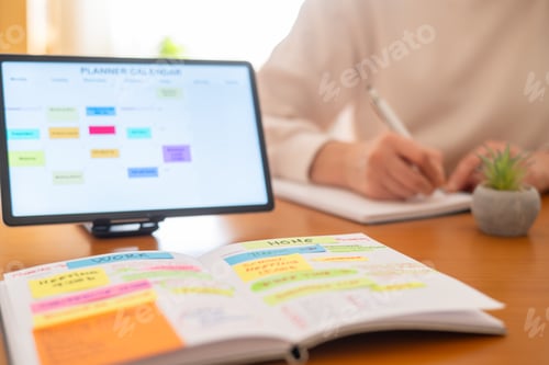 Preview: Person organizing tasks and appointments with planner and tablet for a balanced, organized lifestyle