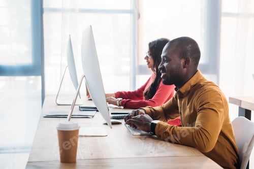 Preview: side view of african american business people working at workplace in office