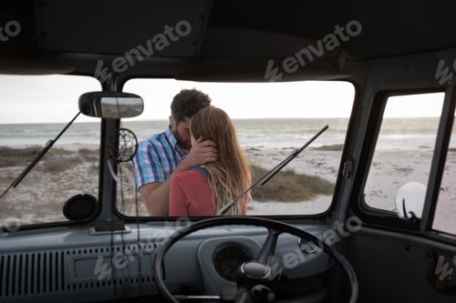 Preview: Rear view of inside view of a camper van of a Caucasian couple hugging each other