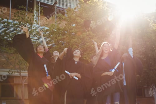 Preview: Successful graduate school kids throwing mortarboard in air in campus
