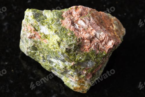Preview: sample of raw unakite mineral on black granite