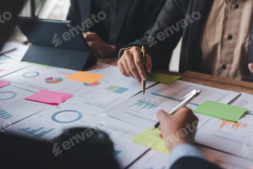 Preview: Groups of businesspeople working together as a team of analytics point to company graphs and charts