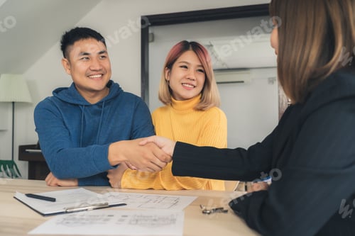Preview: Happy young Asian couple and realtor agent. k. Signing good condition contract.